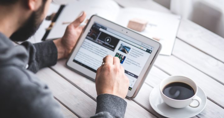 man reading tablet